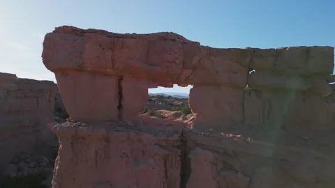 Aerial drone of a natural window in eroded sandstone in mountains of New Mexico. Video stock 248253130