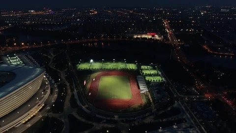 Aerial drone night view of running track with running people. Stadium running Stock Footage 112653068