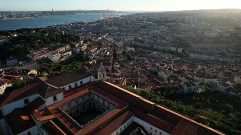 Aerial drone orbit from above Graca viewpoint revealing major Lisbon, Portugal Stock Footage 240664555
