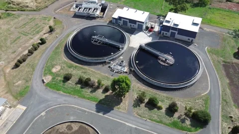Aerial drone orbit around circular water treatment tanks Stock-Footage 332750018