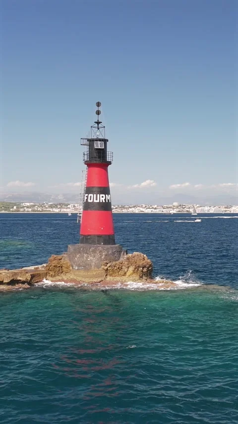 Aerial drone orbit around Fourmigue rock and Juan-les-Pins bay France.vertica Stock Footage 344752592