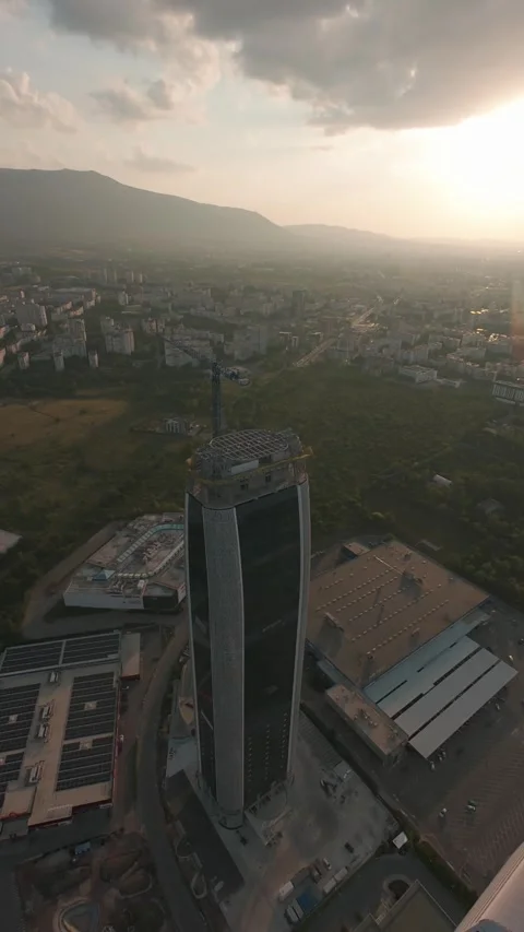 Aerial drone orbit around modern skyscraper at sunset in Sofia, Bulgaria, Stock Footage 340814790