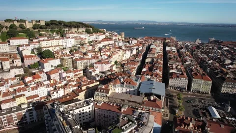 Aerial drone orbit of Baixa District in Lisbon, Portugal with major landmarks Stock Footage 240663889
