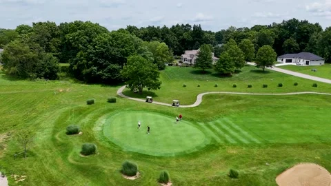 Aerial Drone Orbit of Golf Green with Sand Bunker and Luxury Villas Stock Footage 337656527