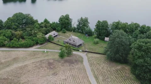 Aerial Drone Orbit Left Shot of Thatched Cottages in Ethnographic Park Stock Footage 324975755