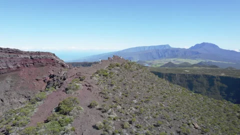 Aerial drone orbit over red rocky crater cliffs Reunion Island Stock Footage 317882090