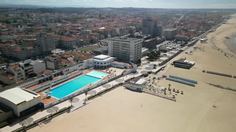 Aerial drone orbit of swimming pool in Espinho, Portugal revealing the beach Stock Footage 284091933