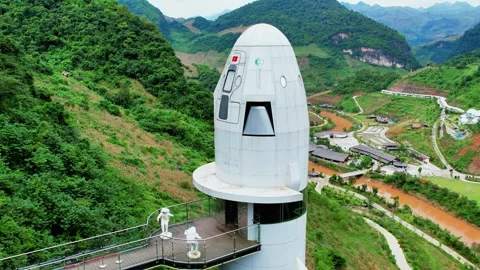 Aerial drone orbit of unique rocket shaped glass cliff elevator 4K Stock Footage 337149448