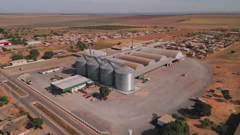 Aerial drone orbiting grain silos and agricultural warehouse in Minas Gerais Stock Footage 341052250