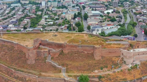 Aerial drone orbits above Gori Fortress in Georgia, mapping the oval citadel Stock Footage 340765931