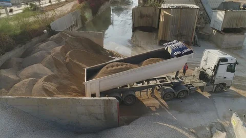 Aerial Drone over cement factory. Trucks loading and pouring sand. Building Stock Footage 123700276