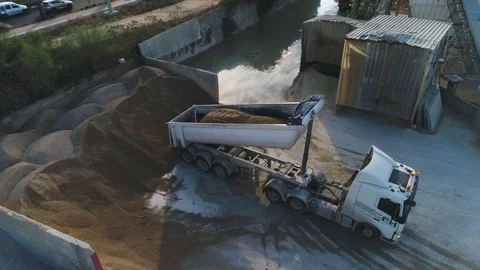 Aerial Drone over cement factory. Trucks loading and pouring sand. Building Stock Footage 123700683