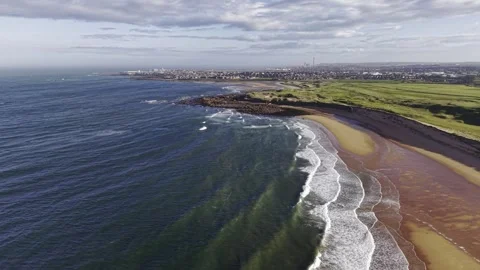 Aerial Drone Over Clear Ocean Waves Along Sandy Coastline Video stock 333784425