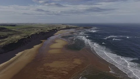 Aerial Drone Over Coastal Cliffs and Sandy Beach with Ocean Waves Video stock 333784401