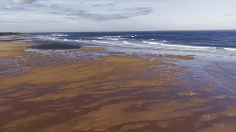 Aerial Drone Over Low Tide Beach with Waves and Sand Patterns Video stock 333784343