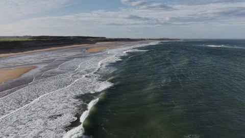 Aerial Drone Over Ocean Waves Breaking Along Sandy Coastline Video stock 333784445