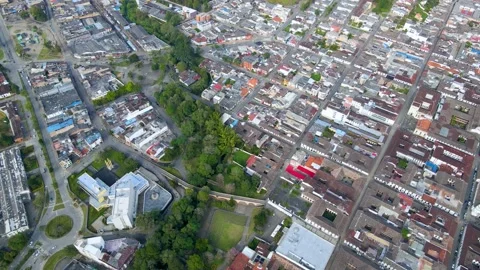 Aerial drone over Popayan with tree-lined park and red roofs Stock Footage 331254612