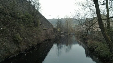 Aerial drone over river going through town of Hebden Bridge Yorkshire Video stock 110824404