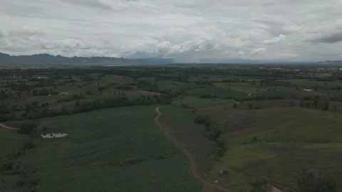 Aerial Drone Over Undulating Dark Hills and Red Dirt Path With Mountain Sil.. Stock-Footage 337392297