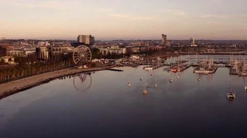 Aerial drone over waterfront marina with ferris wheel Stock Footage