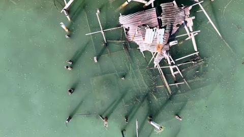Aerial drone overhead view of broken wooden stilt house 스톡 동영상 329240820
