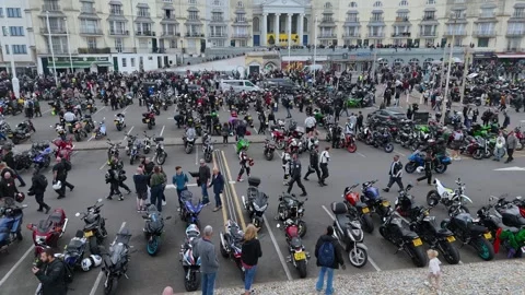 Aerial drone pan right, crowds and motorcycles near Pelham Crescent, Hastings UK Stock Footage 335316462