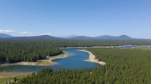 Aerial Drone Pan From River To 3 Sisters Mountain Range, Oregon Stock Footage