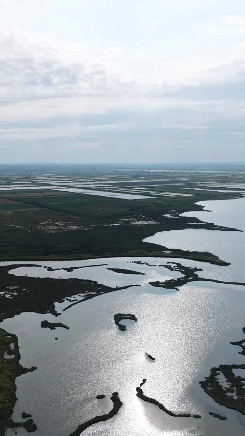 Aerial drone pan of river bend wetlands and mountains in Kavala Greece Video stock 342109514