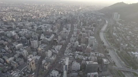 Aerial Drone Pan Shot Over Providencia Skyline And Mapocho River At Sunset Stock Footage 345606487