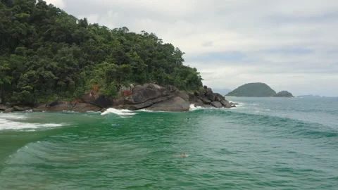 Aerial drone pan wave breaks, forest and tropical beach surf BR UBA 0809 A GR Video stock 143287040