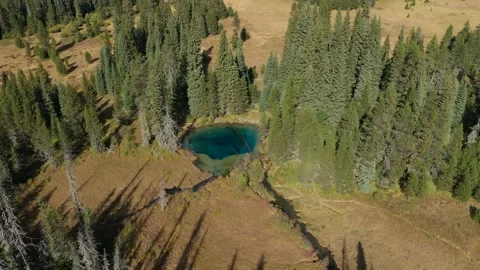 Aerial drone panning down the camera and tracking the transparent turquoise Stock Footage 201036700