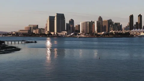 Aerial: Drone Panning Forward Shot Of Motorboats Moving On By Modern Buildings Stock Footage 309420810