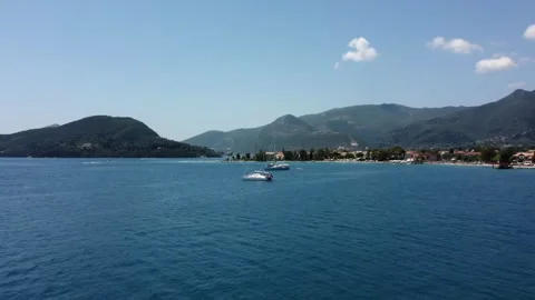 Aerial drone panning low angle view of sail boats anchored near the shore Stock Footage 245604817