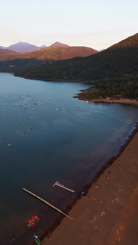 Aerial drone panning shot left to right of Pucon city, Villarrica lake, and.. Stock Footage 339210488