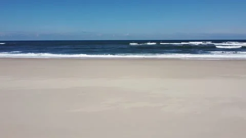 Aerial Drone Panning to Side View - Waves Crashing in a Beach with Golden San Video stock 153586768