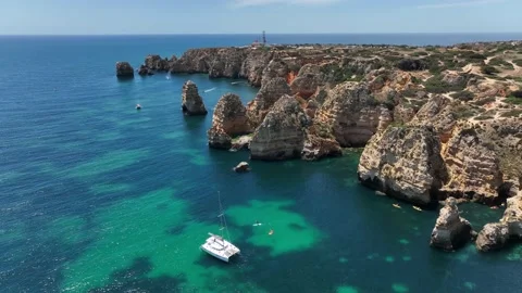Aerial drone panorama view of idyllic nature landscape rocky cliff boats sailing Stock Footage 201730934