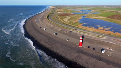 Aerial drone panoramic view of a coastal road on a stone dike with a red Stock Footage 336213652