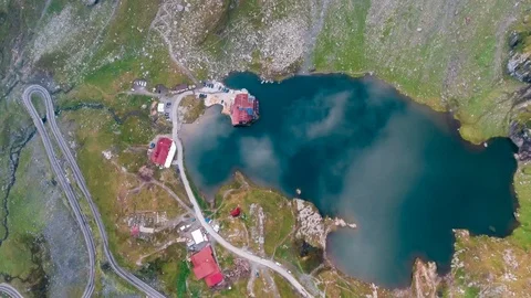 Aerial drone panoramic view over mountain Balea lake at sunrise above the clouds Video stock 97066366