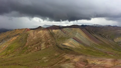 Aerial drone panoramic view of the rainbow colored mountain and huge Andes peaks Stock Footage 105886597