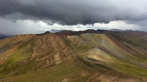 Aerial drone panoramic view of the rainbow colored mountain and huge Andes peaks Stock Footage 105886639