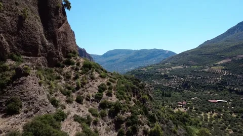 Aerial drone passing cliffs and fertile Mediterranean plain in Greece Video stock 314955929