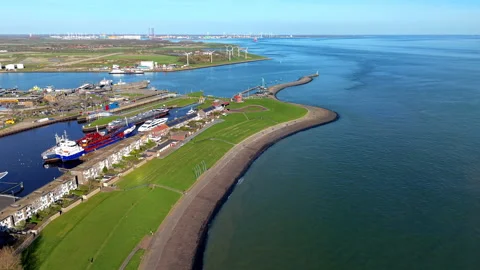 An aerial drone perspective captures curved coastal dike protecting Vlissingen 스톡 동영상 335316662