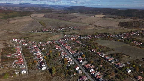 An aerial drone perspective captures a small rural village nestled within Vidéo 348228272