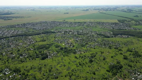 Aerial drone perspective capturing verdant landscape, revealing compact Stock Footage 316245077