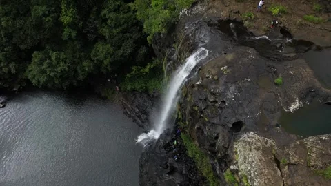 Aerial drone perspective looking down at a powerful cascade plunging over a Stock Footage 341000386