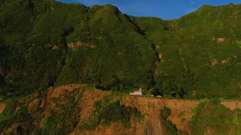 Aerial drone perspective of a remote coastal village with a traditional white Vídeo Stock 336221144