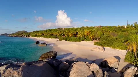 Aerial drone pull-away shot over white sand beach with bolders in the BVI Stockbeeldmateriaal 51632375