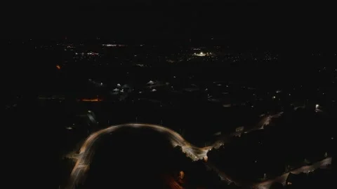 Aerial Drone Pull Back and Ascend Over Winding Night Road Video stock 323769963