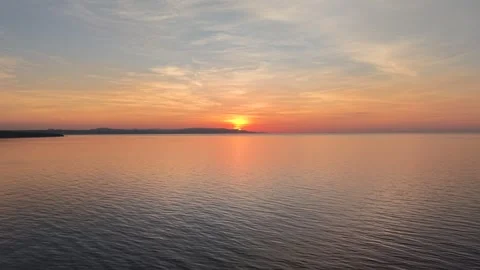 Aerial Drone Pull Back Over Ocean at Sunrise, Bohol Coast with Mountains, 4K Vídeo Stock 335734686