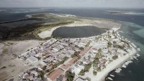Aerial Drone Pull Back Over Island Town, Coastline, and Turquoise Sea in Los Stock Footage 346798366